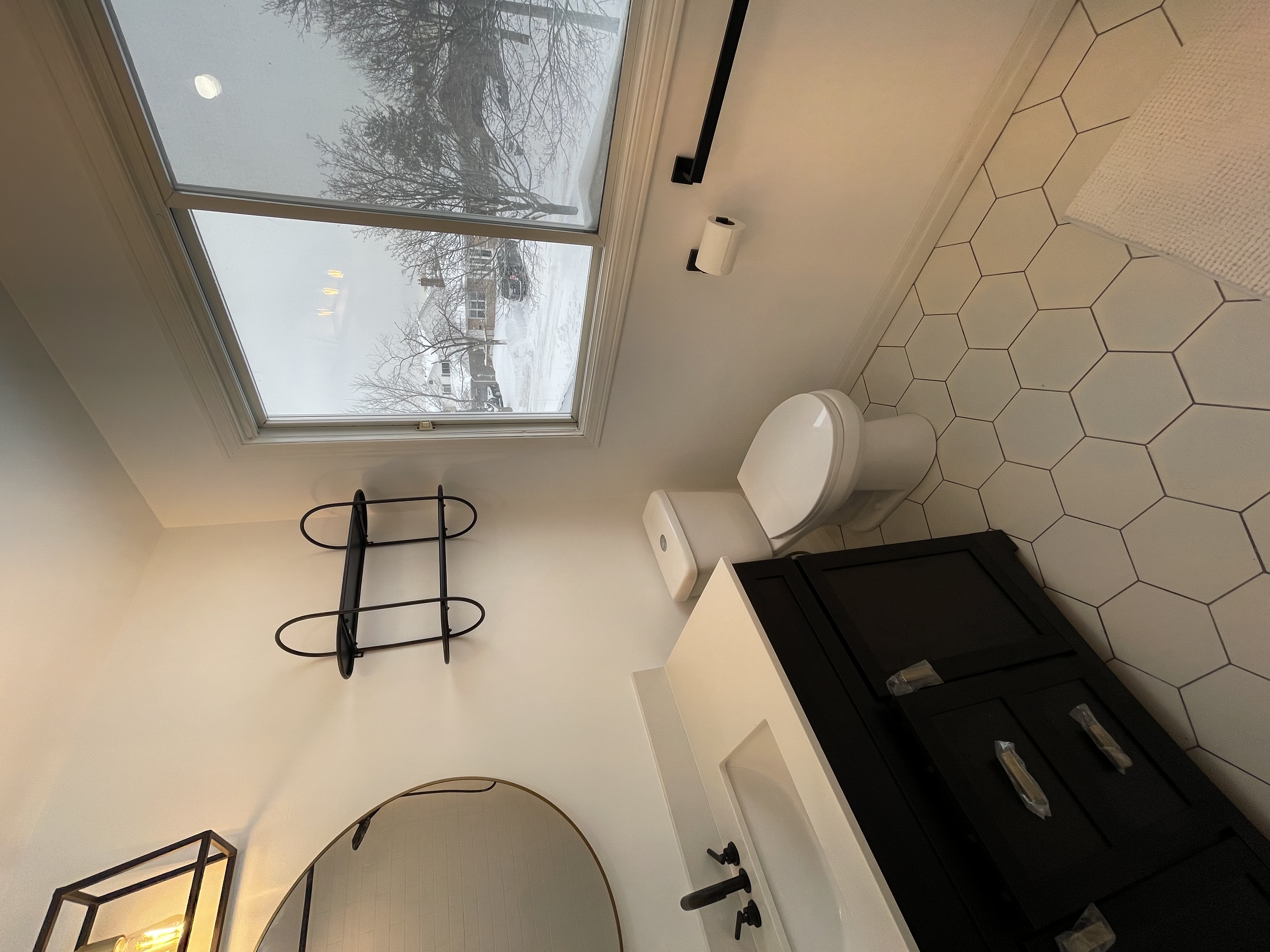 Clean modern bathroom with excellent natural light and strong material contrast — premium portfolio shot — Buchanan, Hamilton | MTC Renovations