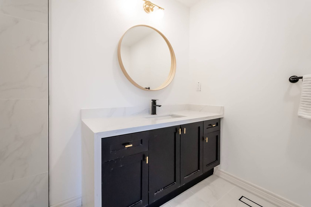Clean modern bathroom with strong dark/light contrast and professional staging — premium portfolio shot — Stonehenge, Hamilton | MTC Renovations