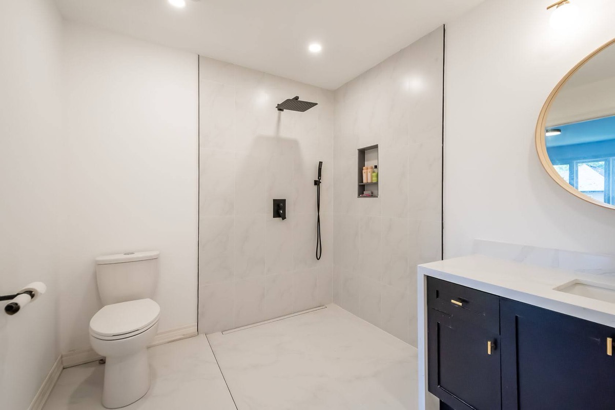 Clean modern bathroom with excellent lighting and professional staging — premium portfolio shot showing contemporary design trends — Stonehenge, Hamilton | MTC Renovations