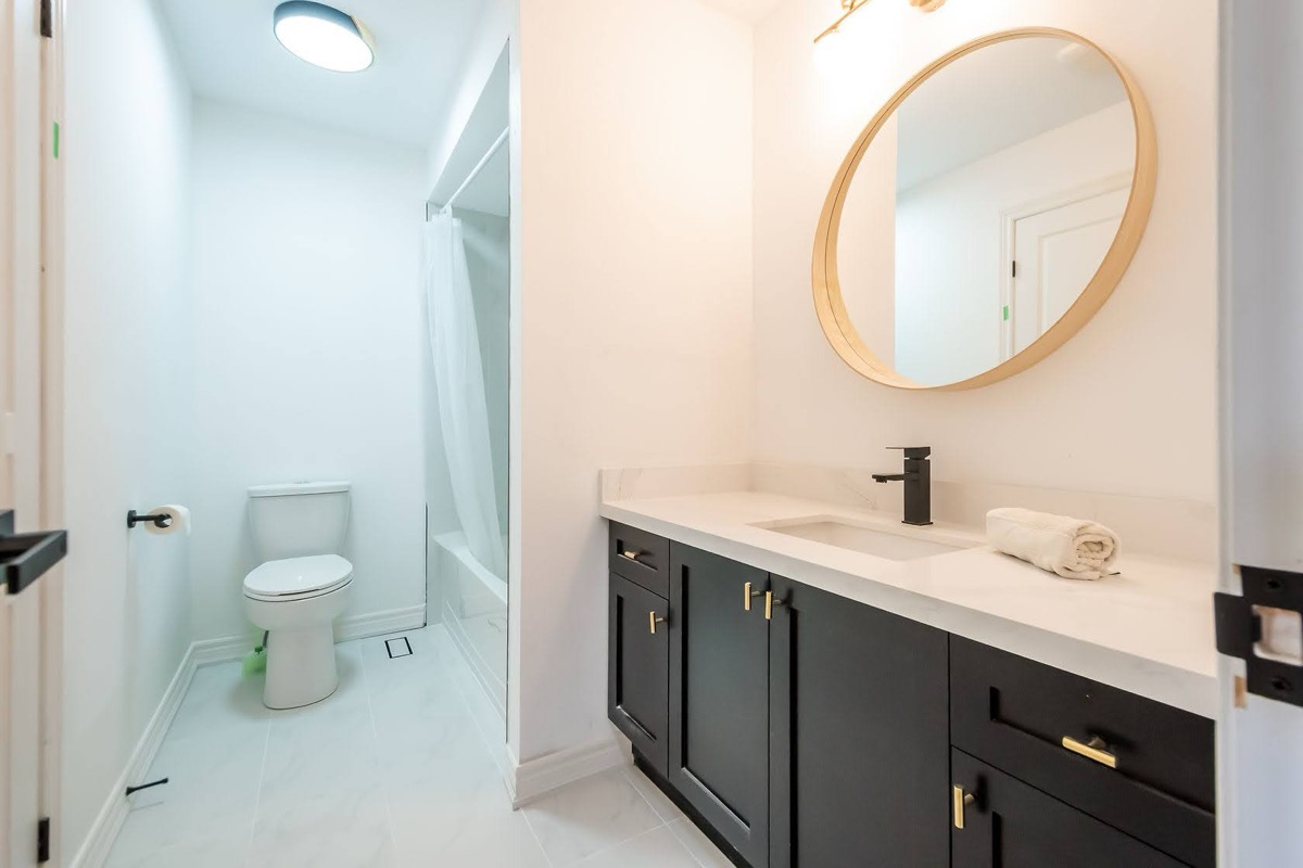Bright finished bathroom with strong material contrast and clean staging — premium portfolio shot — Stonehenge, Hamilton | MTC Renovations