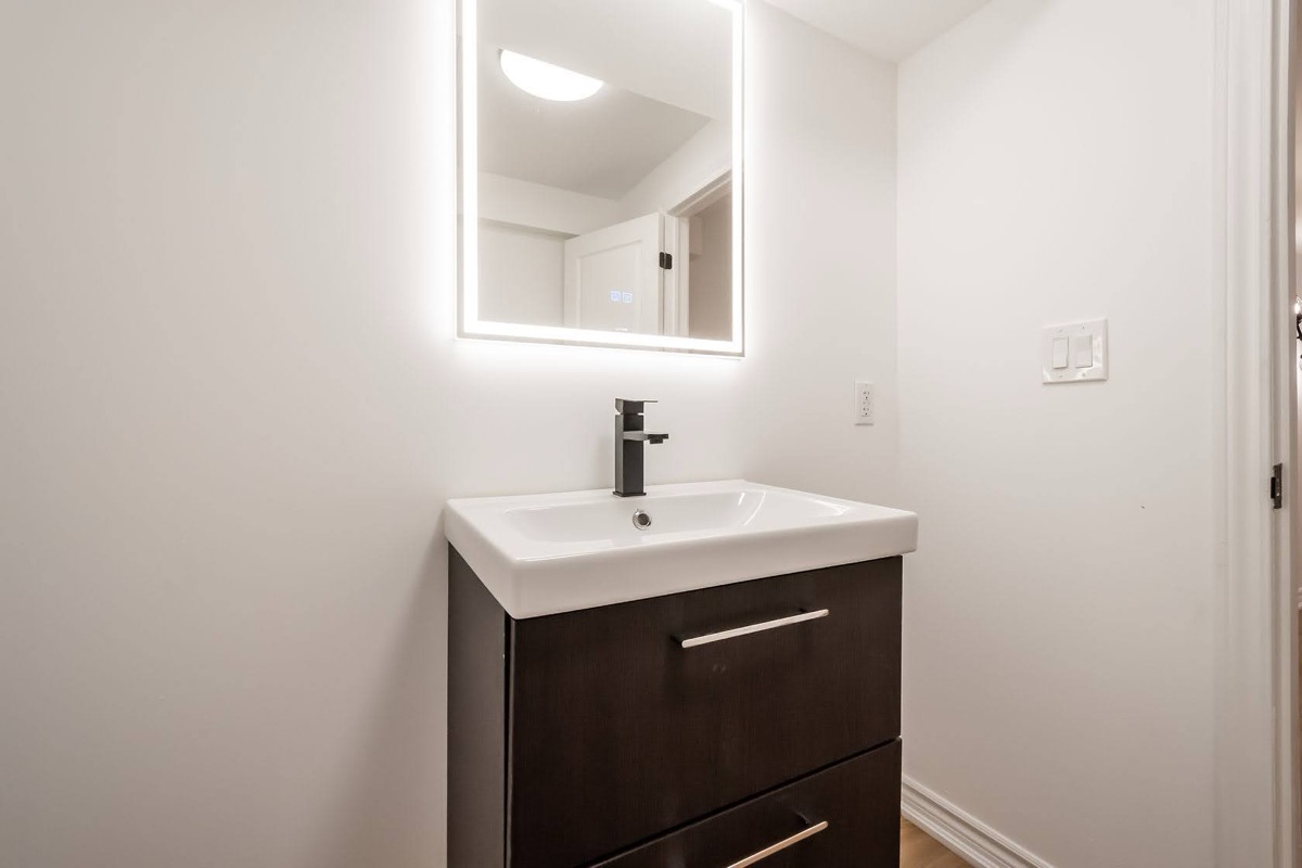 Clean finished bathroom with LED mirror and modern vanity — solid portfolio shot with multi-channel marketing value — Stonehenge, Hamilton | MTC Renovations
