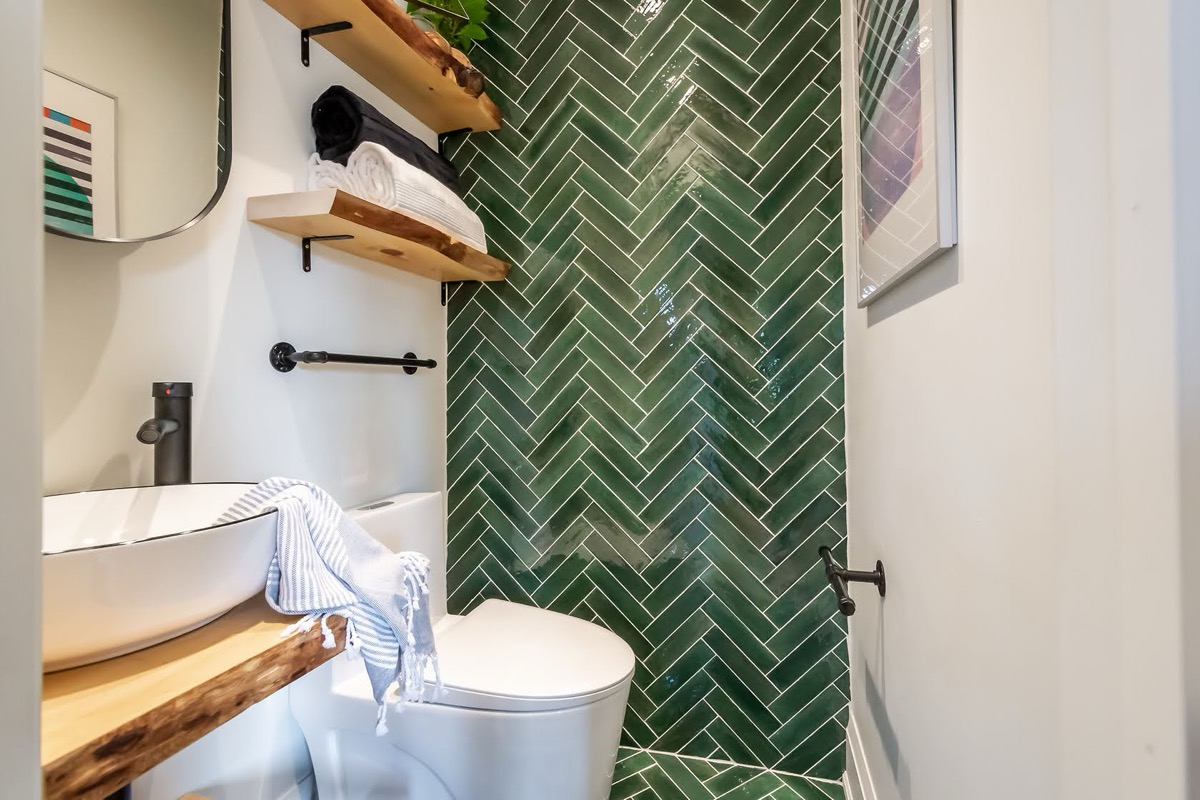 Stunning finished powder room with dramatic green herringbone tile and live-edge wood vanity — premium portfolio shot — Rosedene, Hamilton | MTC Renovations