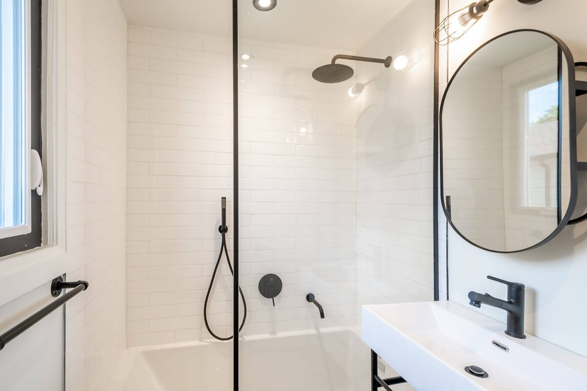 Bright modern bathroom with black fixtures and white subway tile — premium portfolio shot with strong design appeal — Rosedene, Hamilton | MTC Renovations