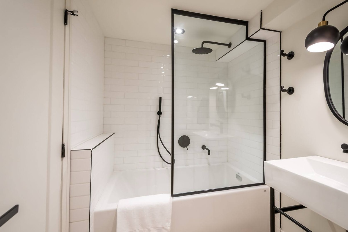 Modern finished bathroom with clean lines, black fixtures, and professional lighting — premium portfolio shot — Rosedene, Hamilton | MTC Renovations