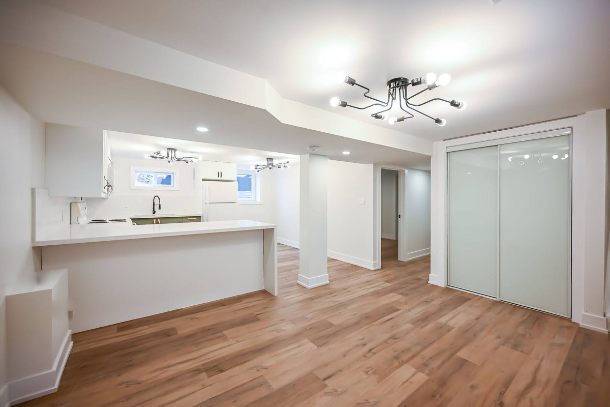 Bright finished basement suite with modern fixtures and beautiful hardwood — Winchester, Hamilton | MTC Renovations
