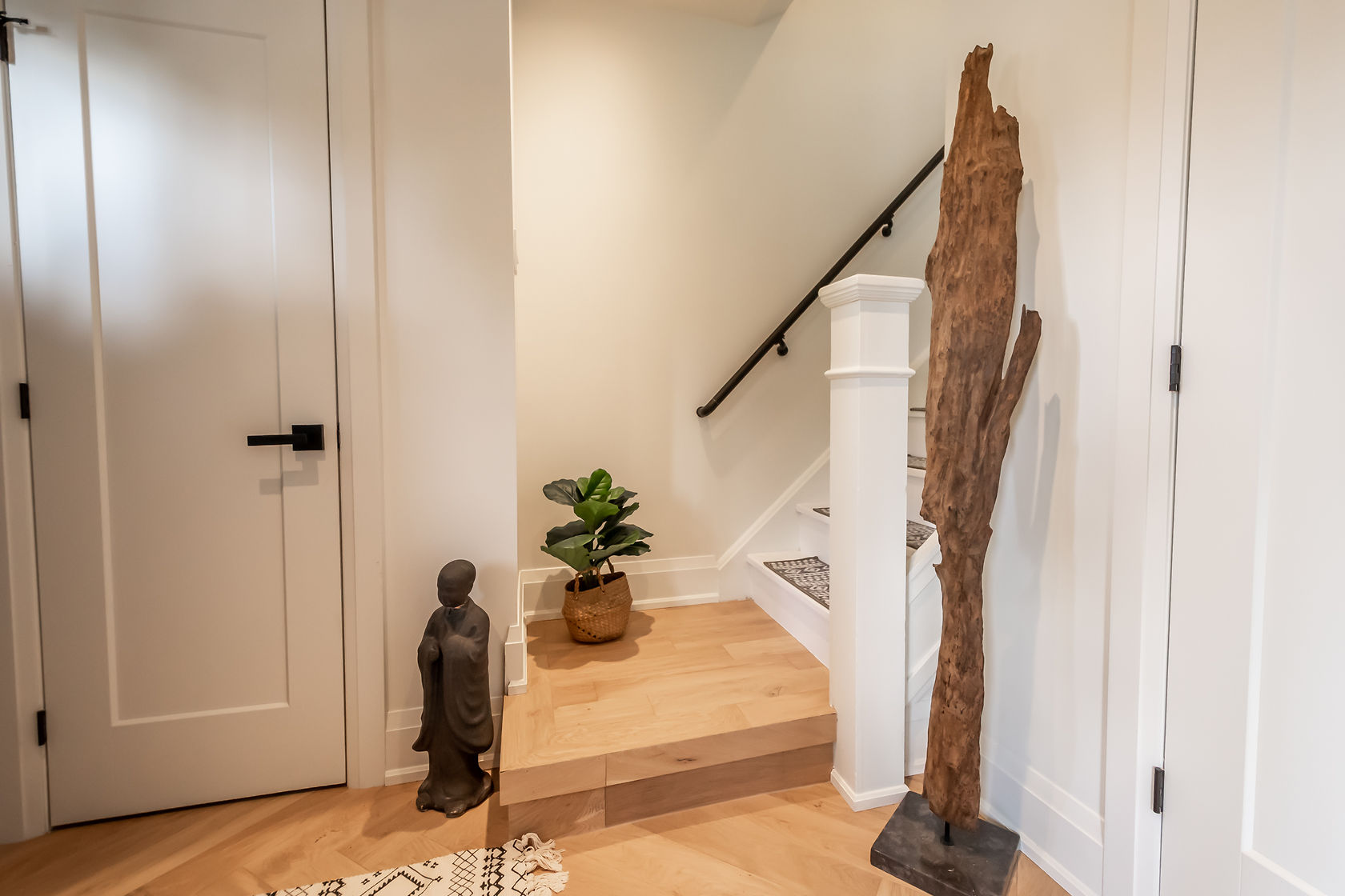 Beautifully finished stairway with warm wood flooring, clean white millwork, and professional staging — Rosedene, Hamilton | MTC Renovations