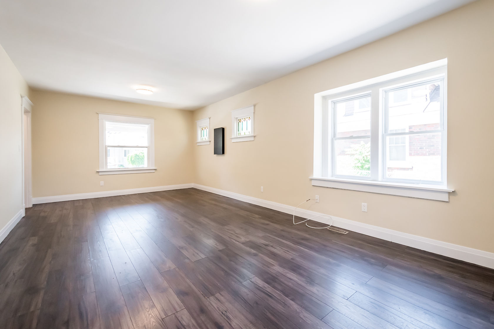 Clean finished room with rich hardwood floors and bright natural light — Eastchester, Hamilton | MTC Renovations