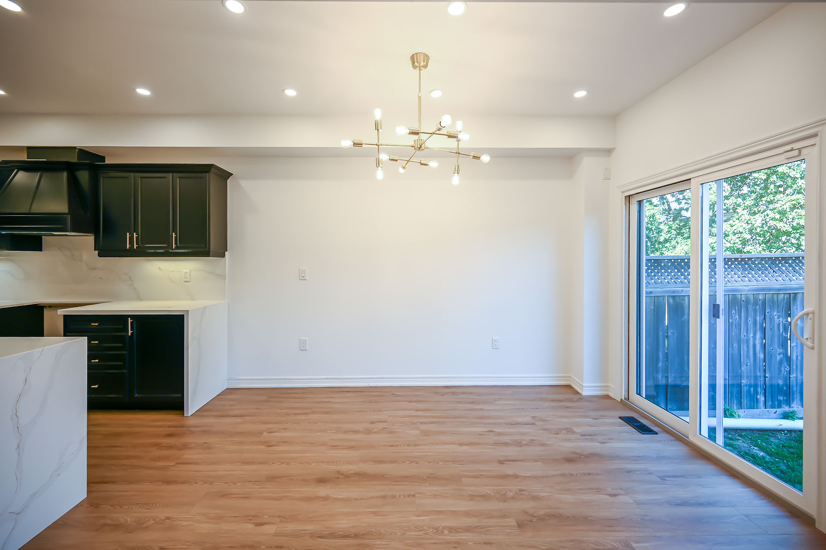 Bright open-concept kitchen with excellent natural light, clean staging, and strong material contrast — premium portfolio shot — Stonehenge, Hamilton | MTC Renovations