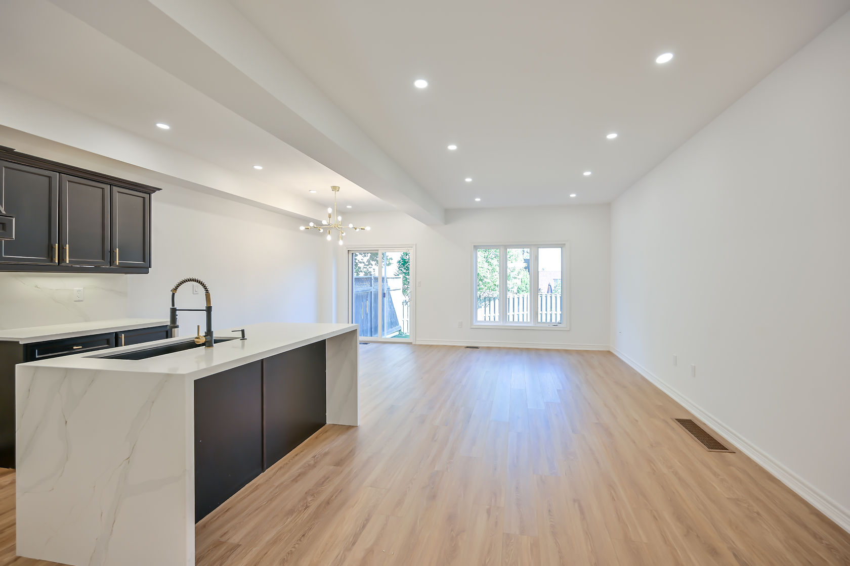Bright open-concept kitchen with excellent natural light, clean staging, and strong material contrast — premium portfolio shot — Stonehenge, Hamilton | MTC Renovations