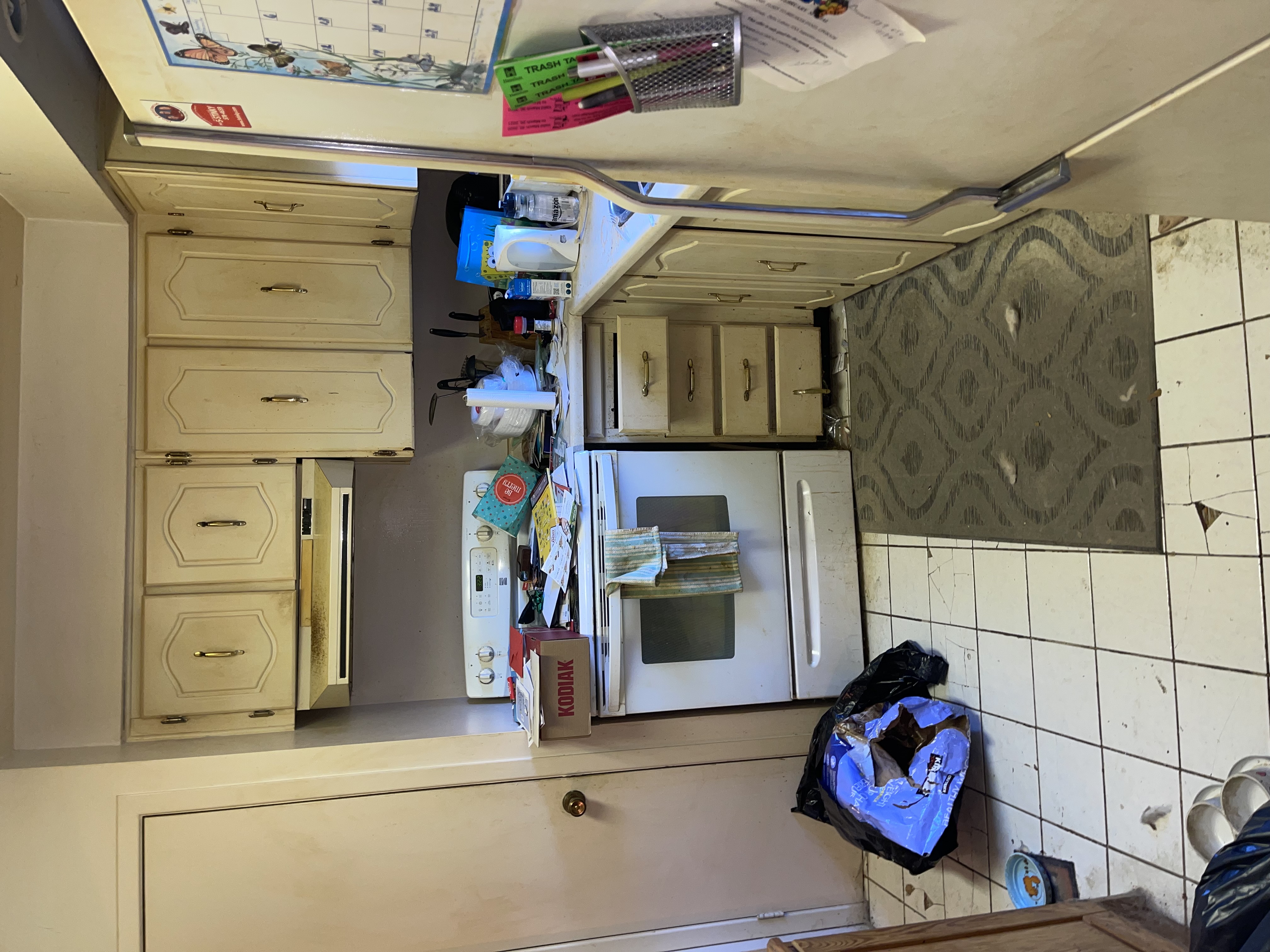 Dated 1980s kitchen with worn cabinets and cluttered counters — excellent before condition for dramatic transformation storytelling — Gateshead, Hamilton | MTC Renovations