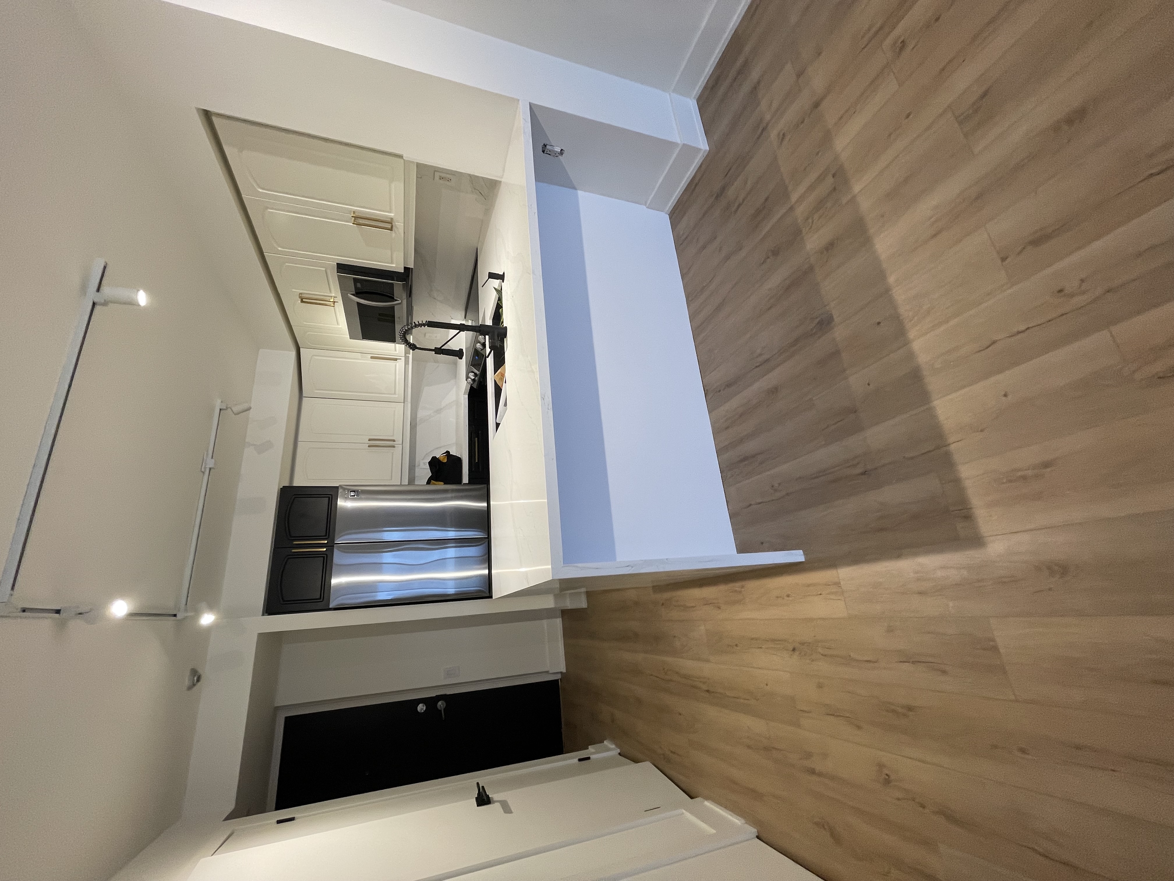 Clean modern kitchen with good lighting and wide-angle view showing full layout — strong portfolio piece — Queensway, Hamilton | MTC Renovations
