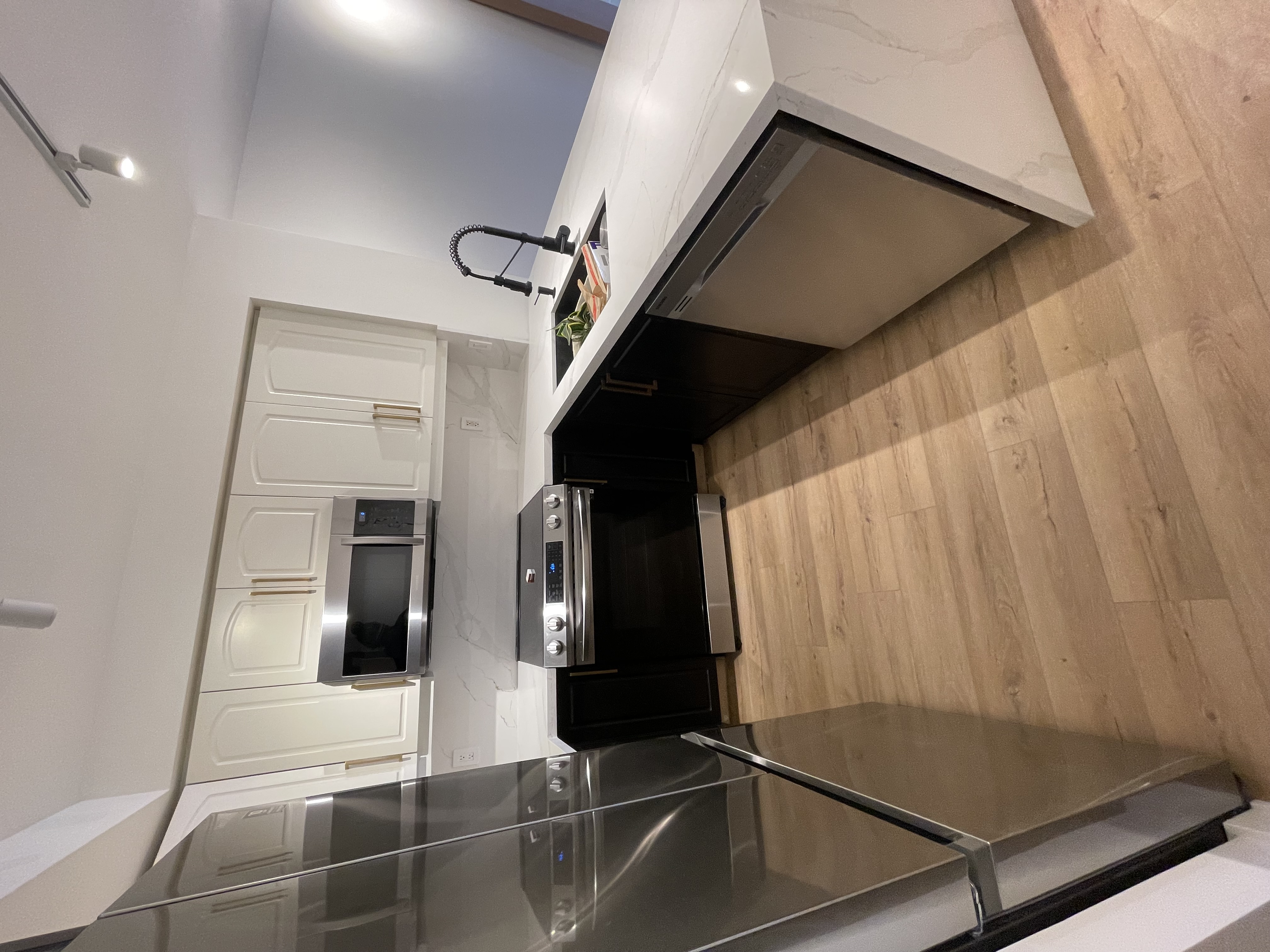Clean finished kitchen with strong two-tone cabinet contrast and quality materials — solid portfolio piece — Queensway, Hamilton | MTC Renovations