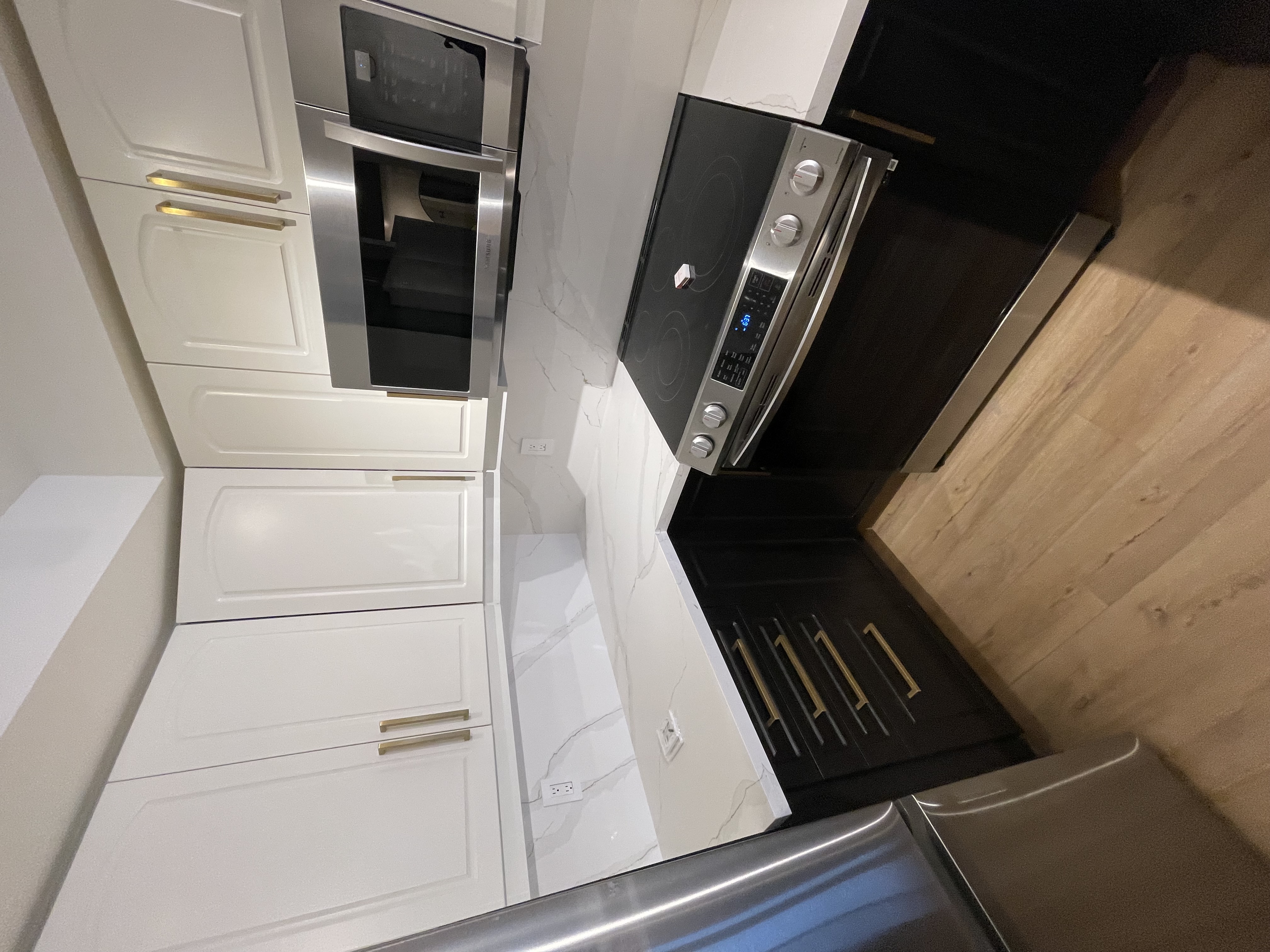 Clean finished kitchen with strong two-tone cabinet contrast and quality quartz countertops — excellent portfolio shot — Queensway, Hamilton | MTC Renovations
