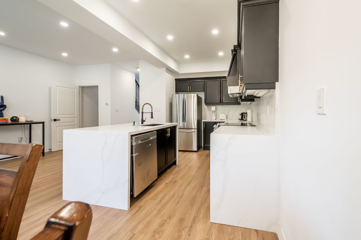 Professional wide-angle finished kitchen with excellent lighting, clean staging, and strong material contrast — premium portfolio shot — Stonehenge, Hamilton | MTC Renovations
