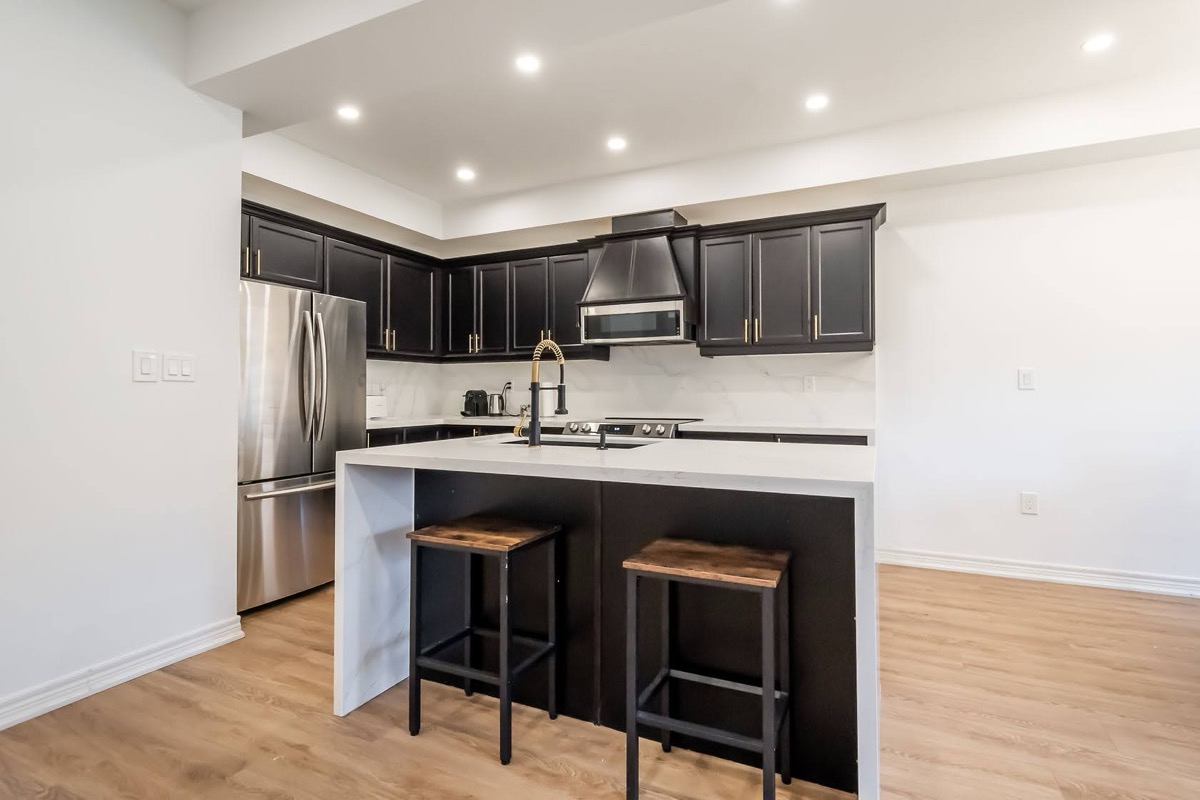 Professional wide-angle finished kitchen with excellent material contrast and clean staging — premium portfolio shot — Stonehenge, Hamilton | MTC Renovations