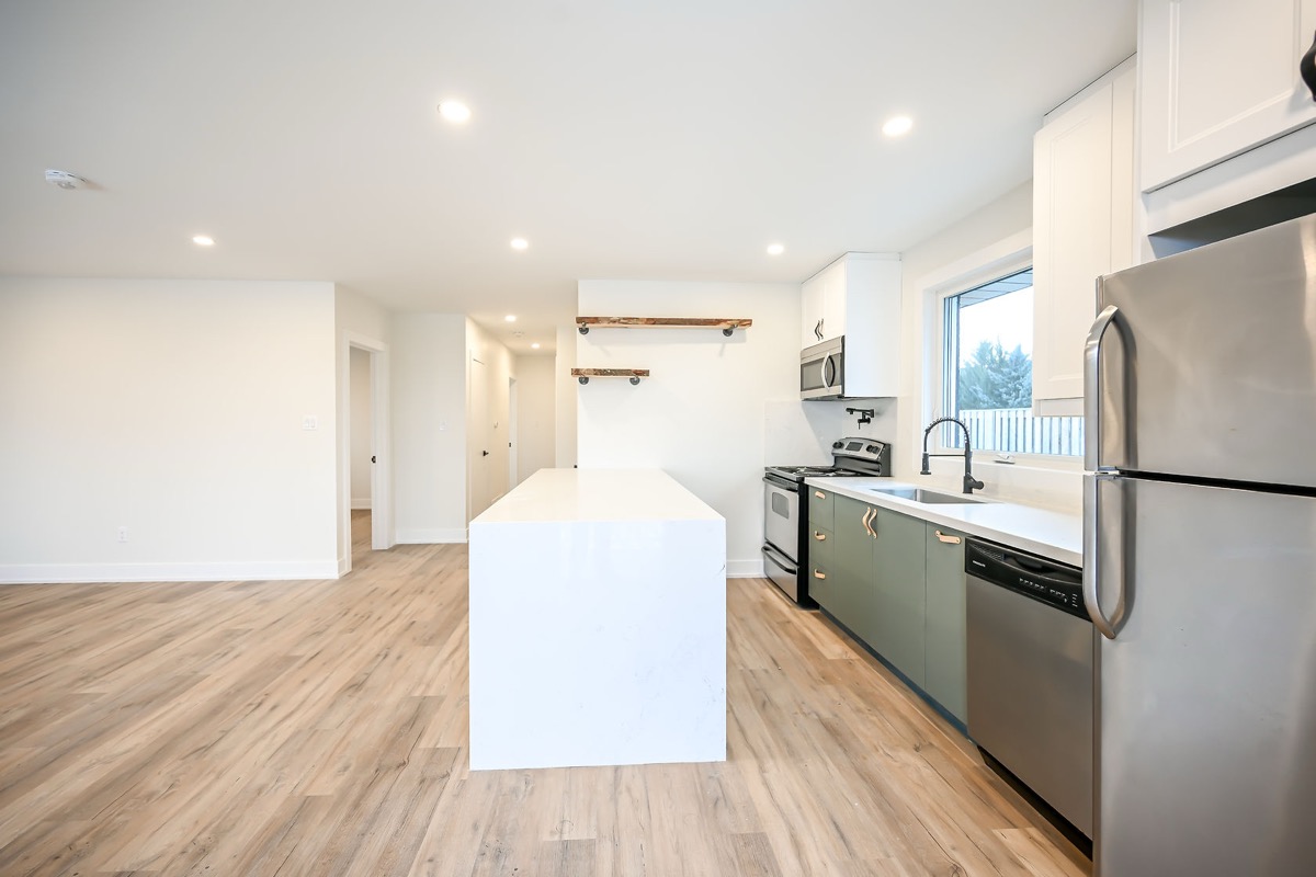Clean modern kitchen with excellent wide-angle composition showing full layout — premium portfolio shot with strong material contrast — Winchester, Hamilton | MTC Renovations
