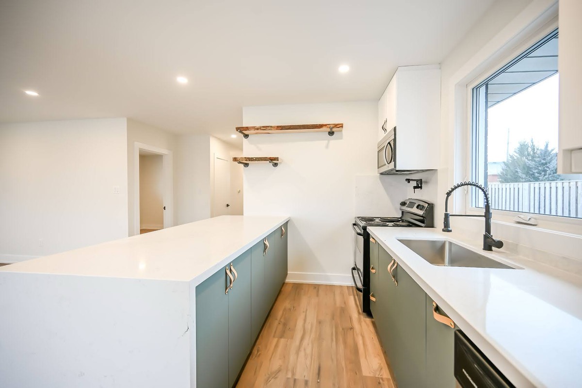 Bright finished kitchen with sage green cabinets and white quartz — premium wide-angle portfolio shot perfect for virtual tours — Winchester, Hamilton | MTC Renovations