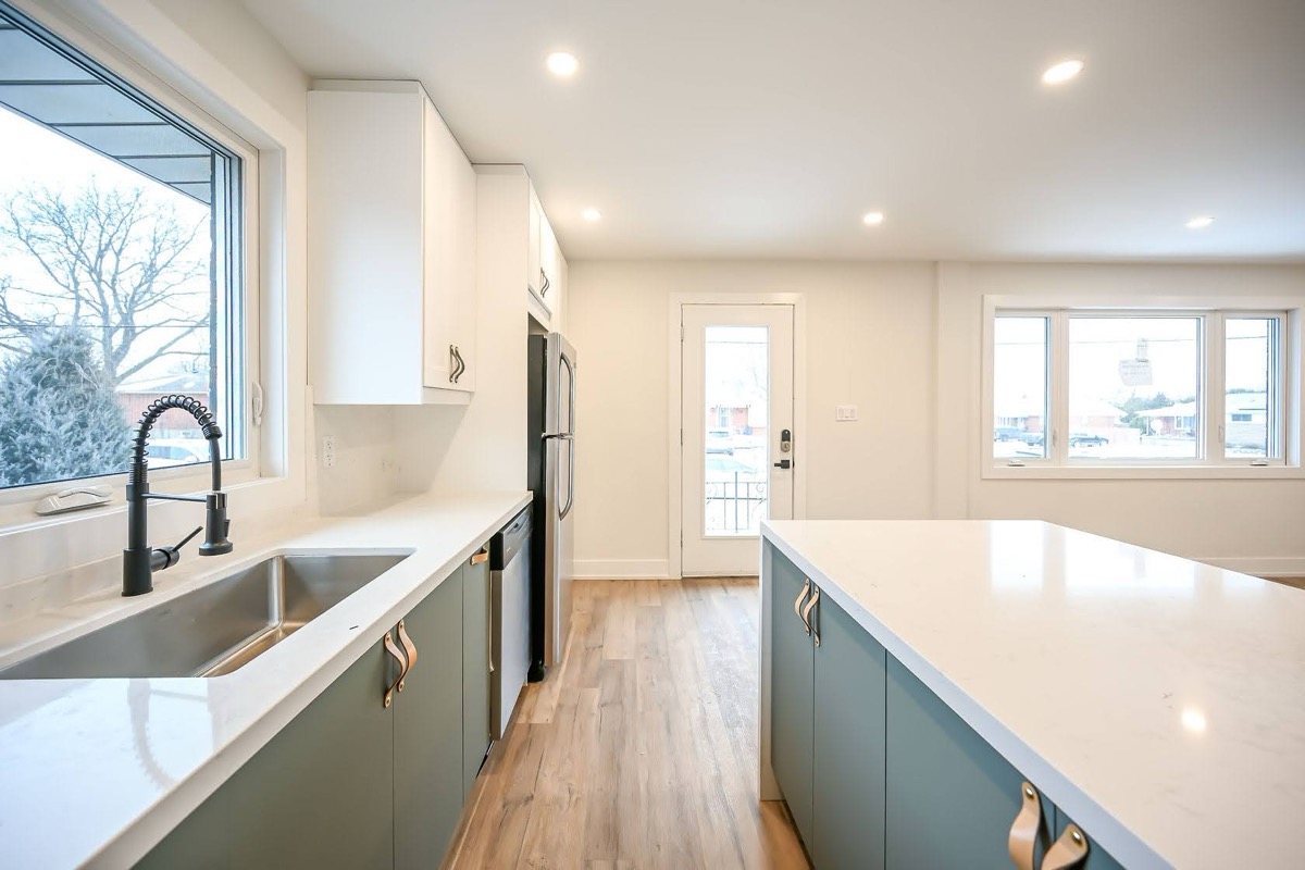 Bright modern kitchen with excellent natural light and strong two-tone cabinet contrast — premium portfolio shot — Winchester, Hamilton | MTC Renovations
