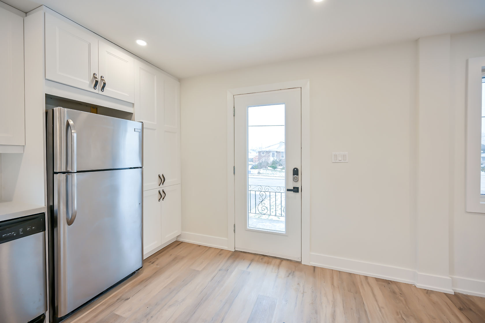 Clean finished kitchen with excellent natural light and professional staging — strong portfolio piece with balcony view bonus — Winchester, Hamilton | MTC Renovations