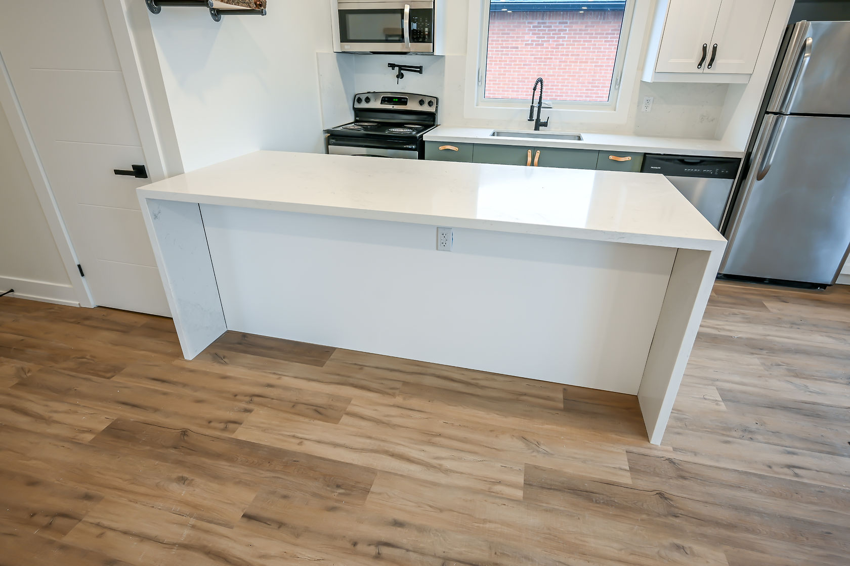 Clean finished kitchen with beautiful wood flooring and white cabinetry — strong portfolio shot with good natural light — Winchester, Hamilton | MTC Renovations