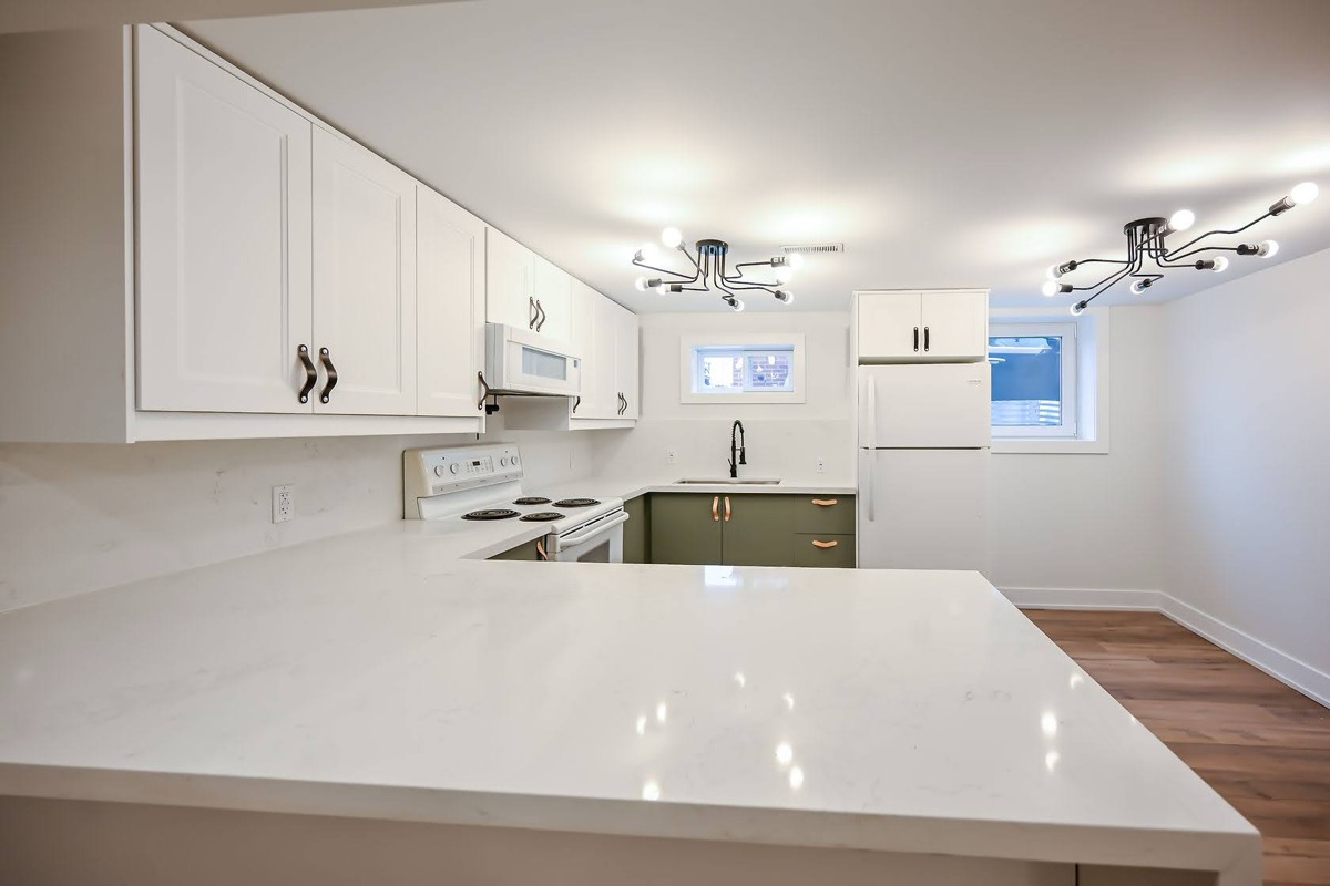 Clean finished kitchen with good lighting and wide-angle view showing full layout — strong portfolio piece — Winchester, Hamilton | MTC Renovations