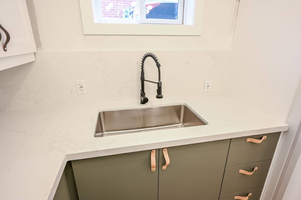Clean finished kitchen detail with modern sage cabinets and copper hardware — strong portfolio shot with current design trends — Winchester, Hamilton | MTC Renovations