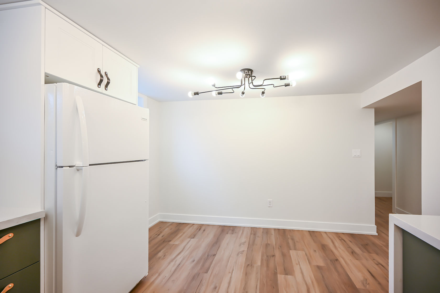 Clean finished kitchen with good lighting and wide-angle view showing full space — strong portfolio shot despite minimal styling — Winchester, Hamilton | MTC Renovations
