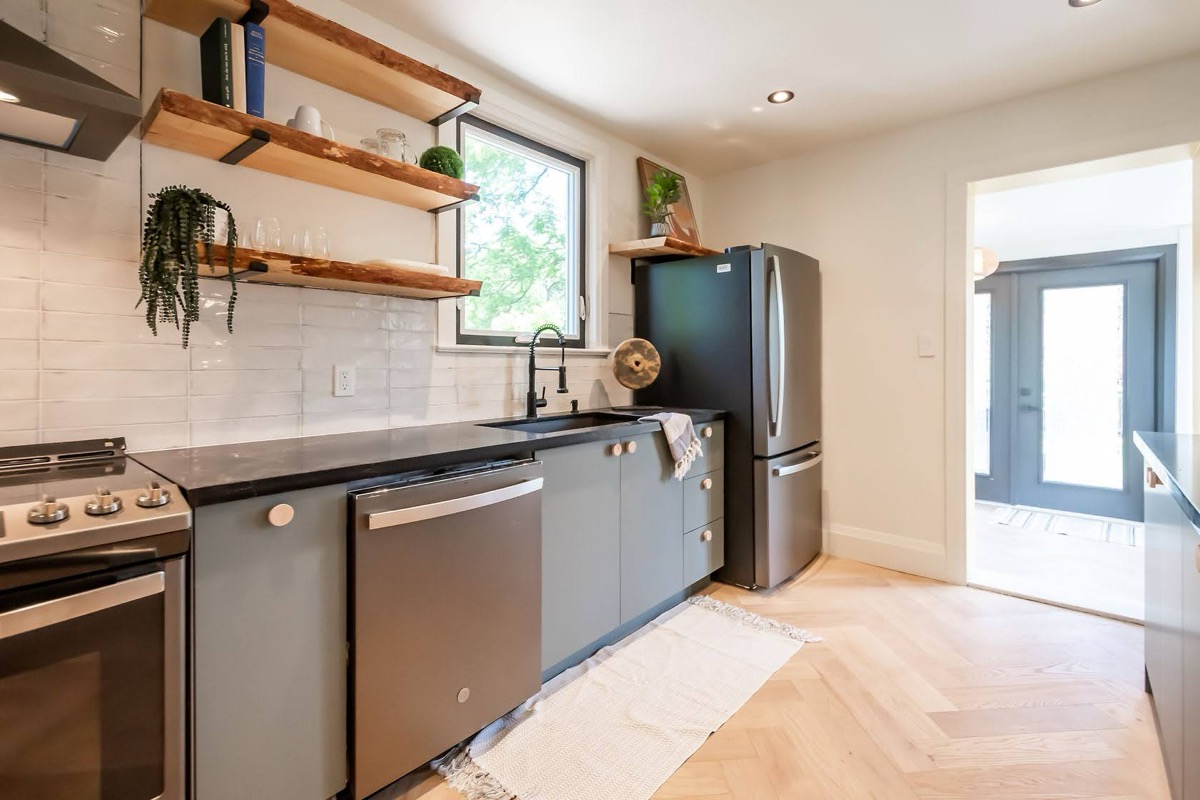 Bright finished kitchen with natural light, clean staging, and strong material contrast — premium portfolio shot — Rosedene, Hamilton | MTC Renovations