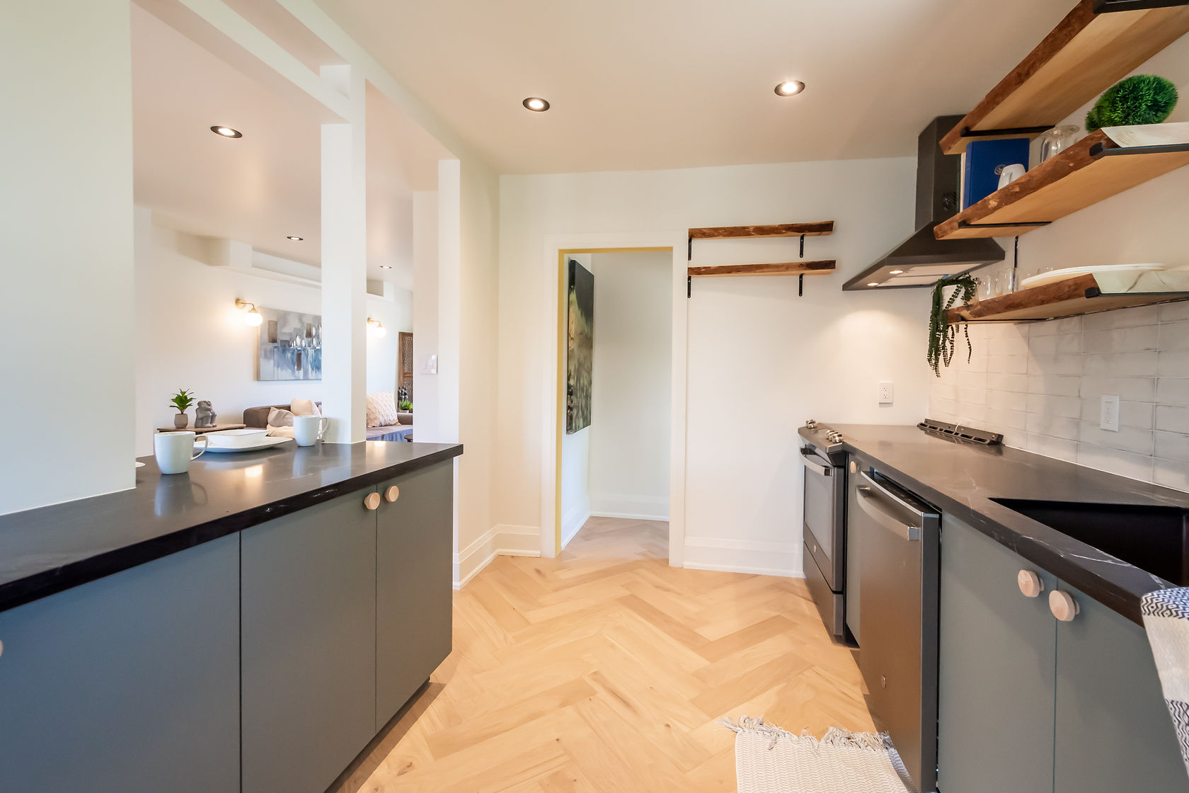 Premium finished kitchen with herringbone floors, sage cabinets, and open shelving — Rosedene, Hamilton | MTC Renovations