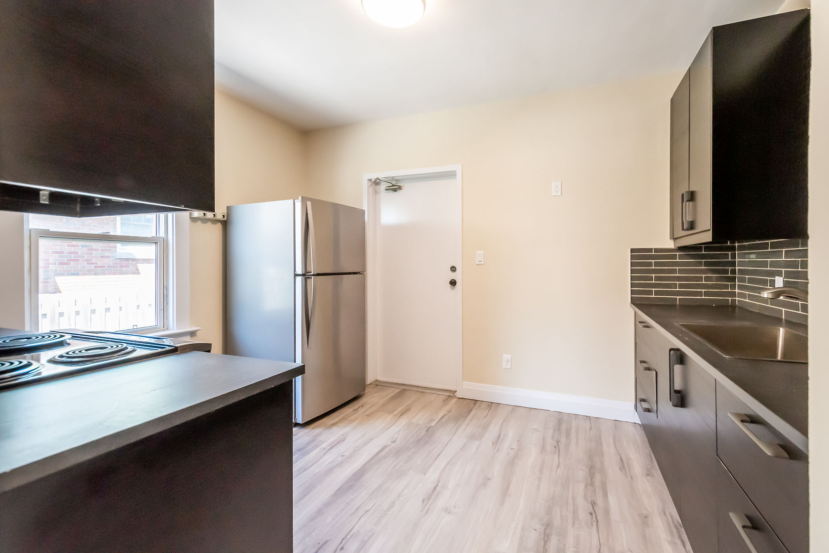 Clean finished kitchen with good lighting and wide-angle view showing full layout — solid portfolio shot — Eastchester, Hamilton | MTC Renovations