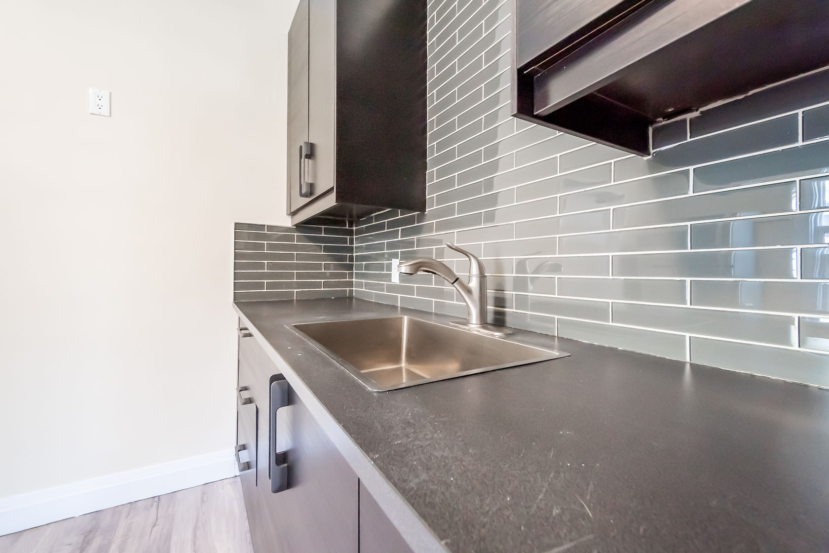 Clean finished kitchen with excellent material contrast between dark quartz counters and white subway tile — strong portfolio shot — Eastchester, Hamilton | MTC Renovations