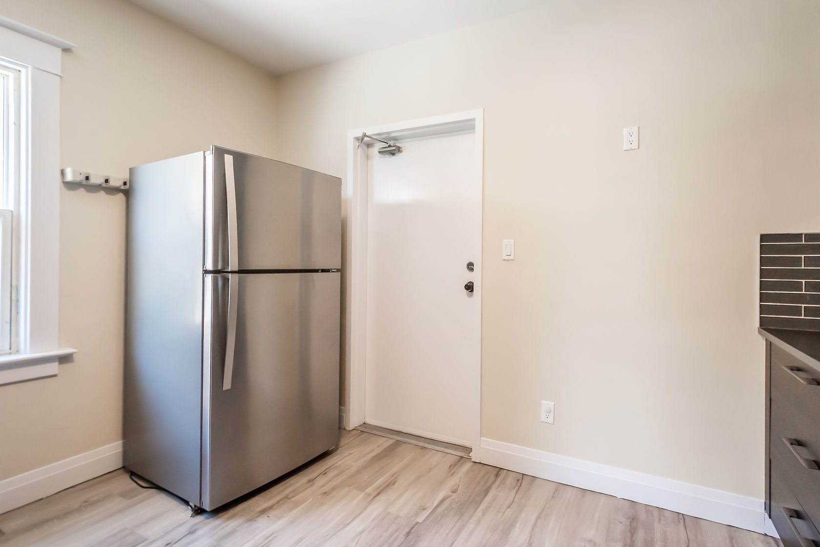 Clean finished kitchen with excellent natural light and professional staging — strong portfolio shot despite minimal cabinetry visible — Eastchester, Hamilton | MTC Renovations