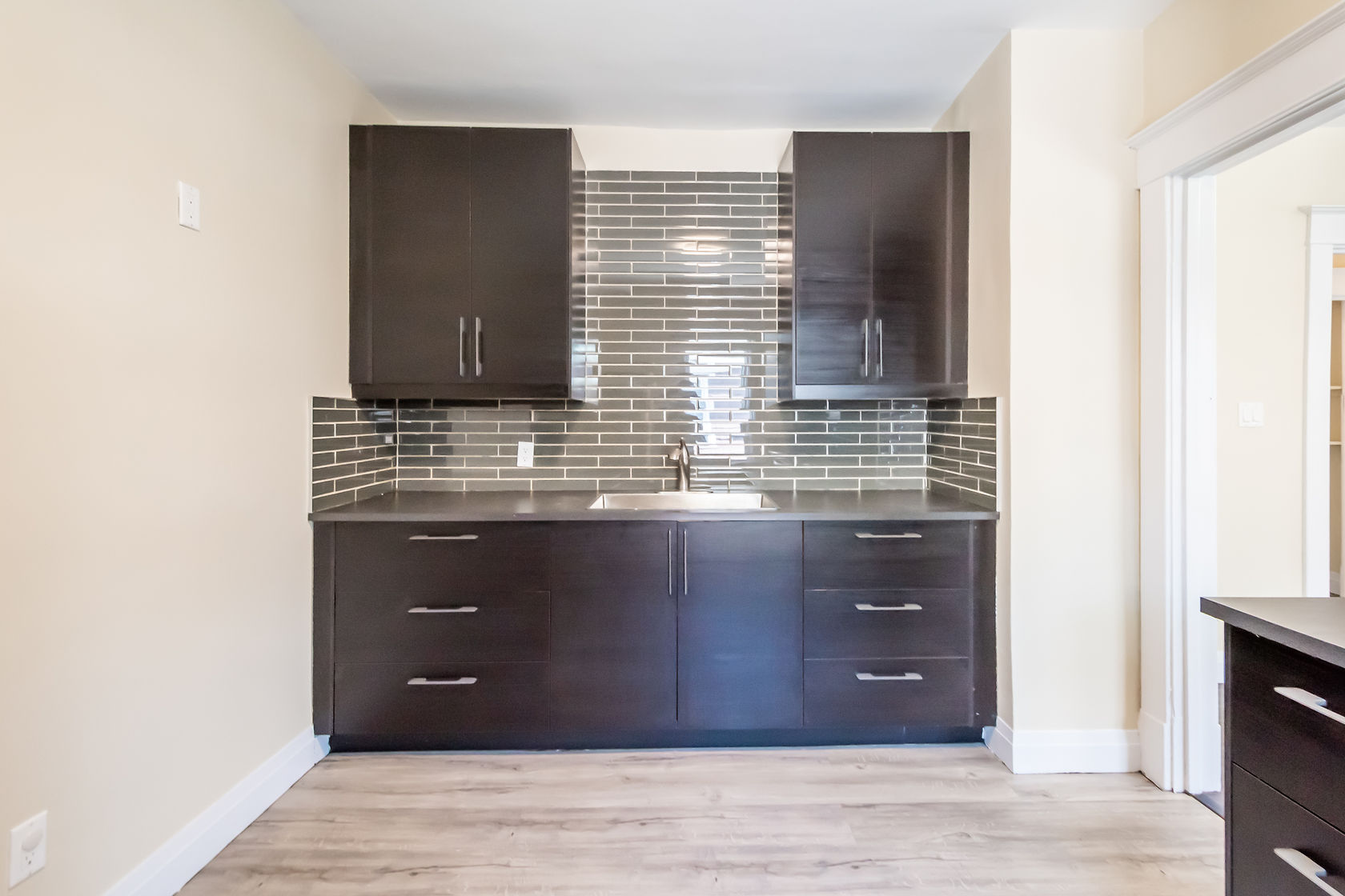 Professional finished kitchen with excellent natural light, clean staging, and strong material contrast — premium portfolio shot — Eastchester, Hamilton | MTC Renovations