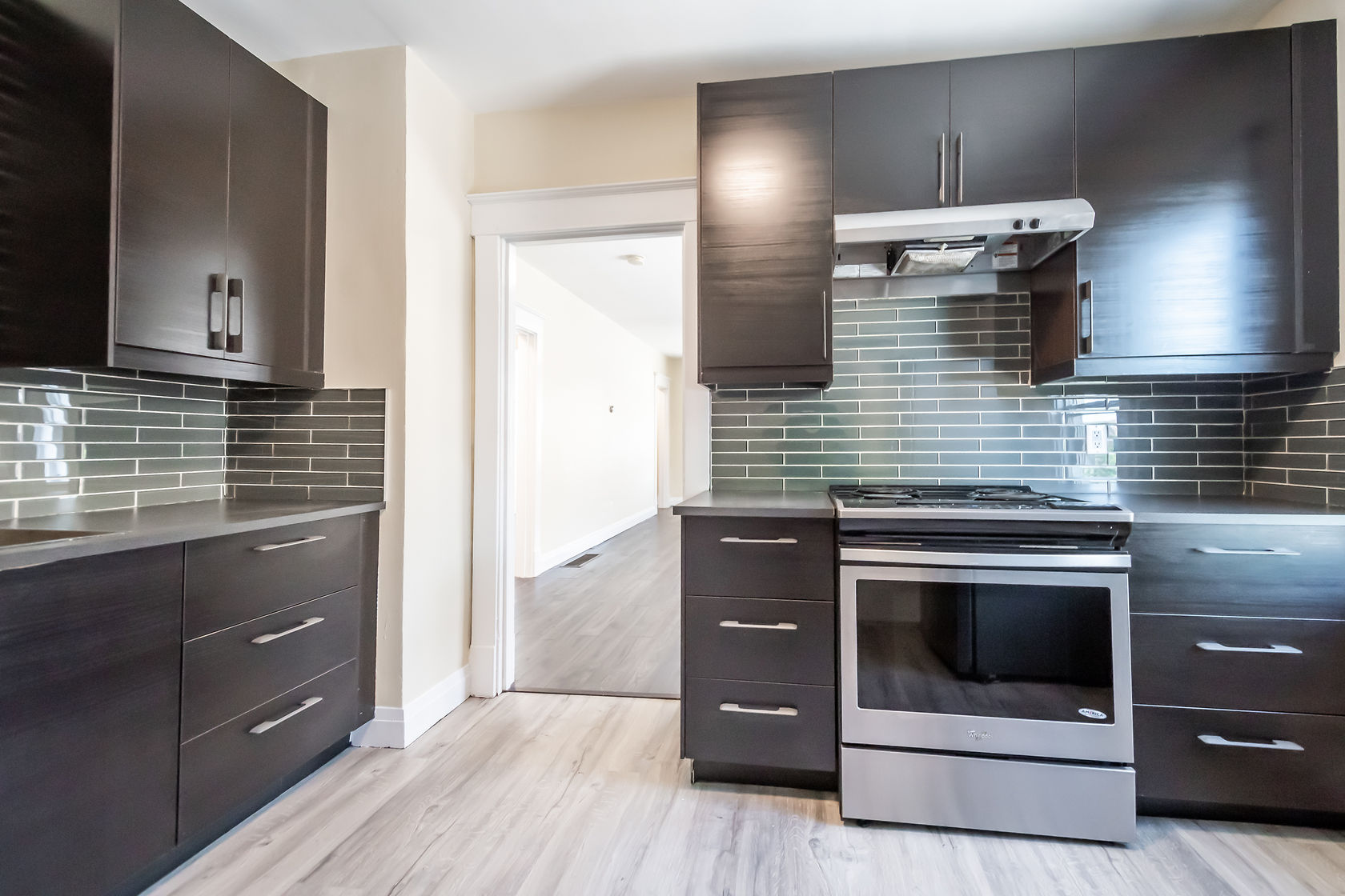 Professional wide-angle finished kitchen with excellent natural light, clean staging, and strong material contrast — premium portfolio shot — Eastchester, Hamilton | MTC Renovations