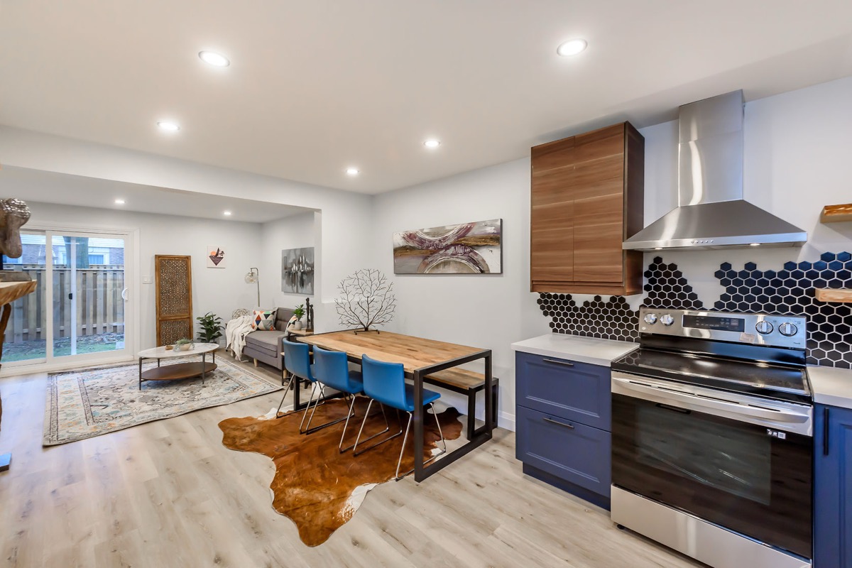 Premium wide-angle finished kitchen with striking blue cabinets, hexagon backsplash, and open-concept flow — Gateshead, Hamilton | MTC Renovations