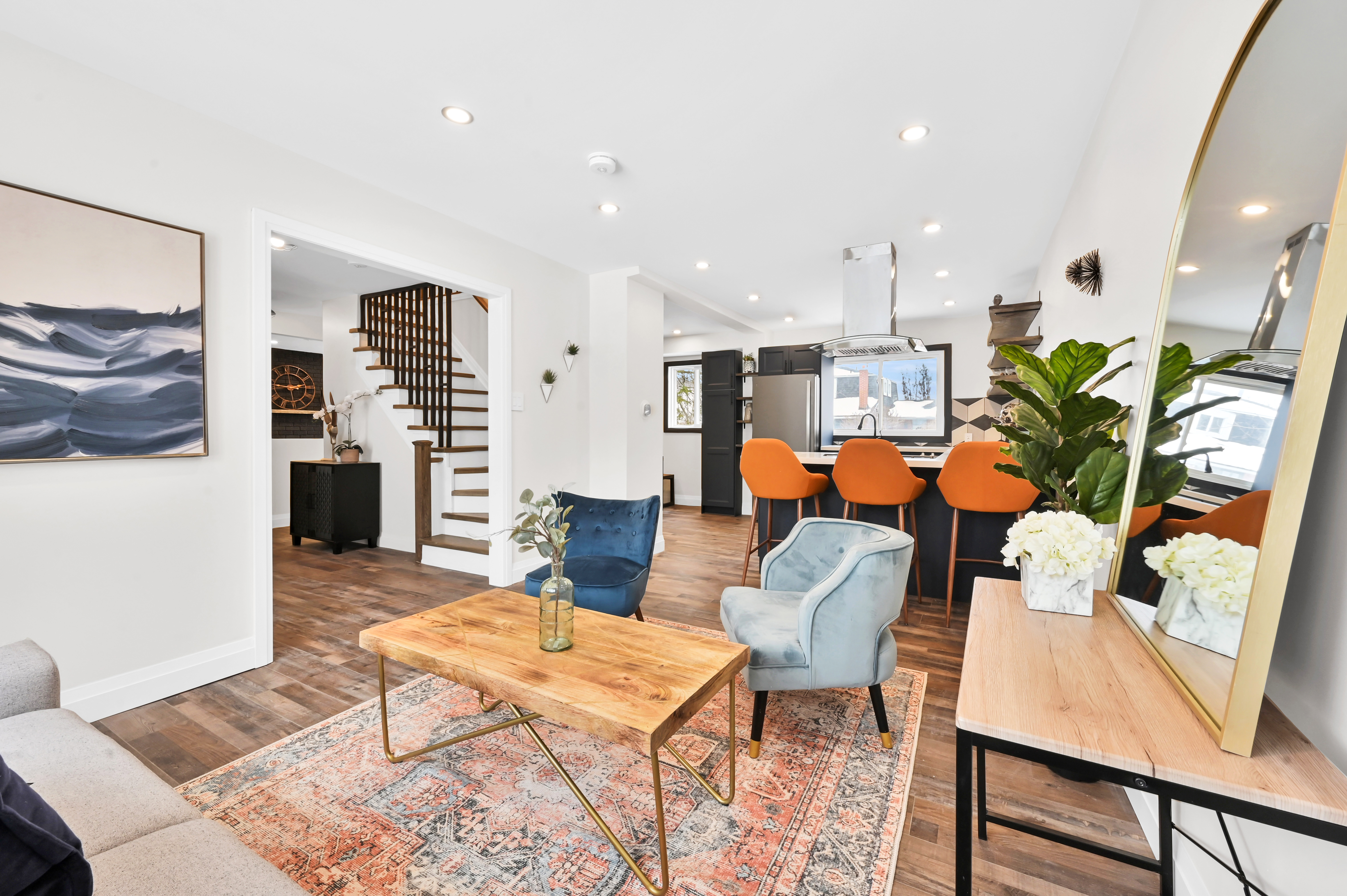 Wide-angle finished living room with fresh painted walls and natural material contrast — Kron, Hamilton | MTC Renovations