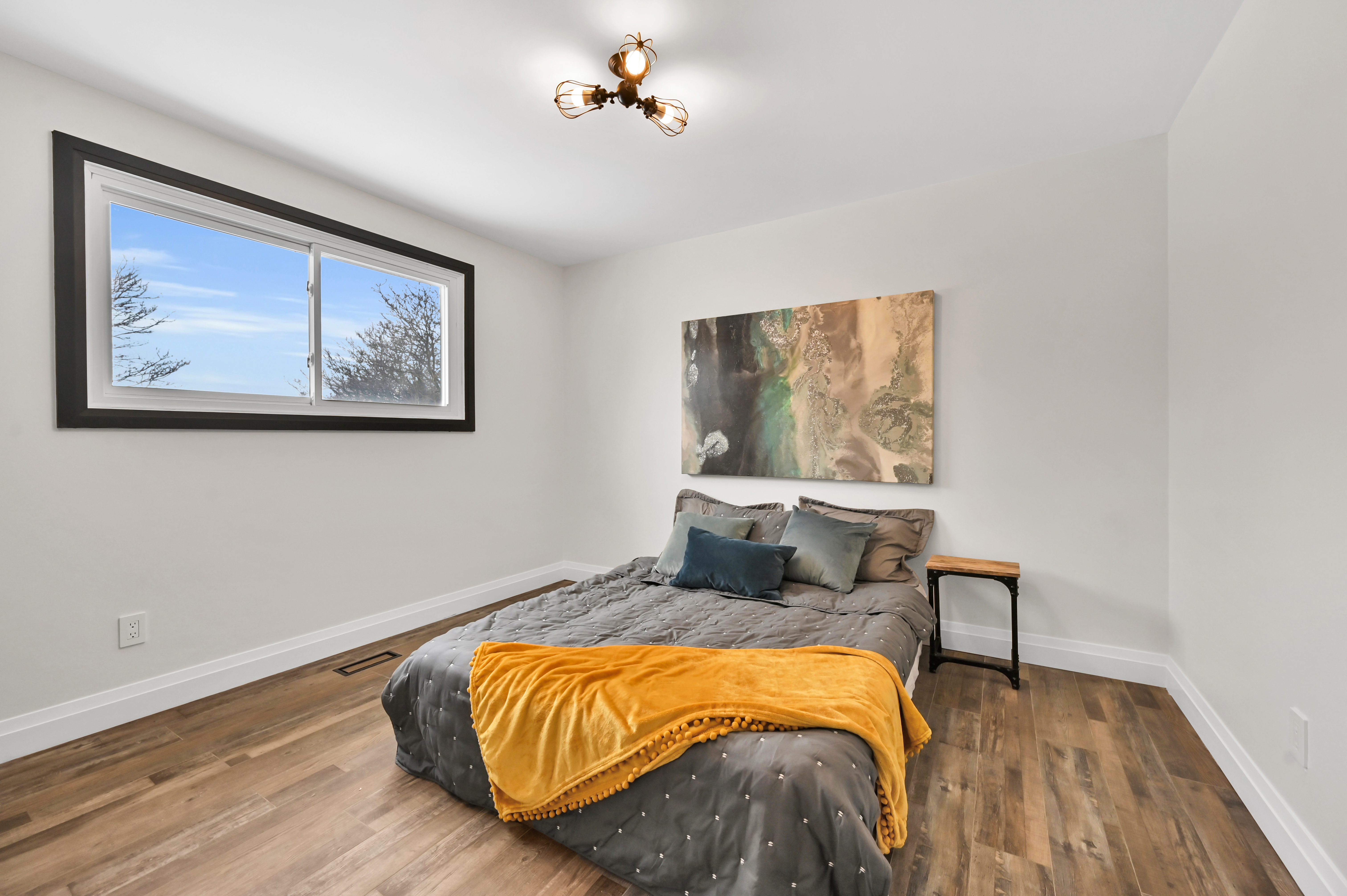Bright bedroom with rich wood floors and freshly painted walls — Kron, Hamilton | MTC Renovations