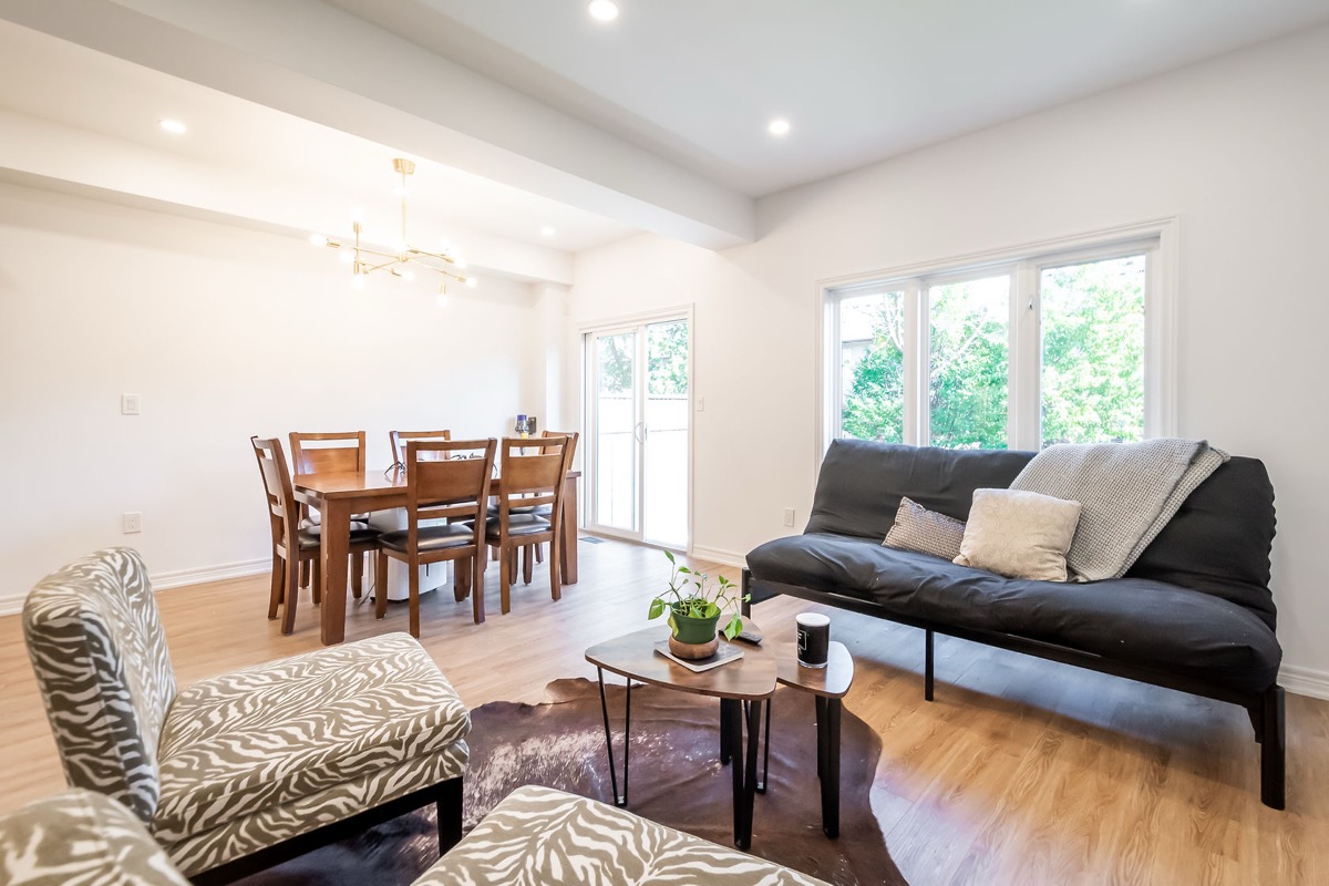 Bright open-concept living space with fresh painted walls and professional staging — Stonehenge, Hamilton | MTC Renovations