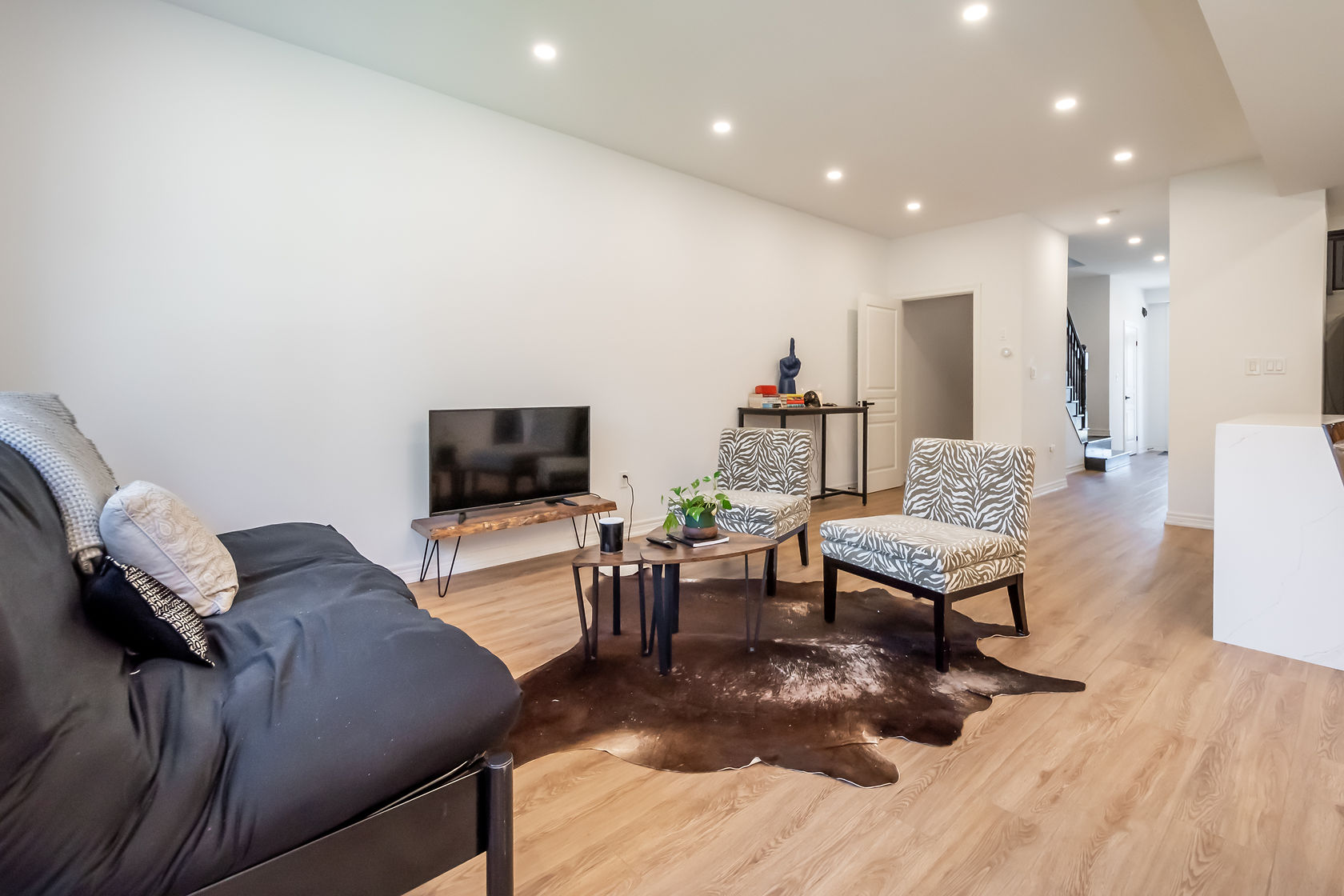 Finished living room with hardwood floors and crisp painted walls — Stonehenge, Hamilton | MTC Renovations