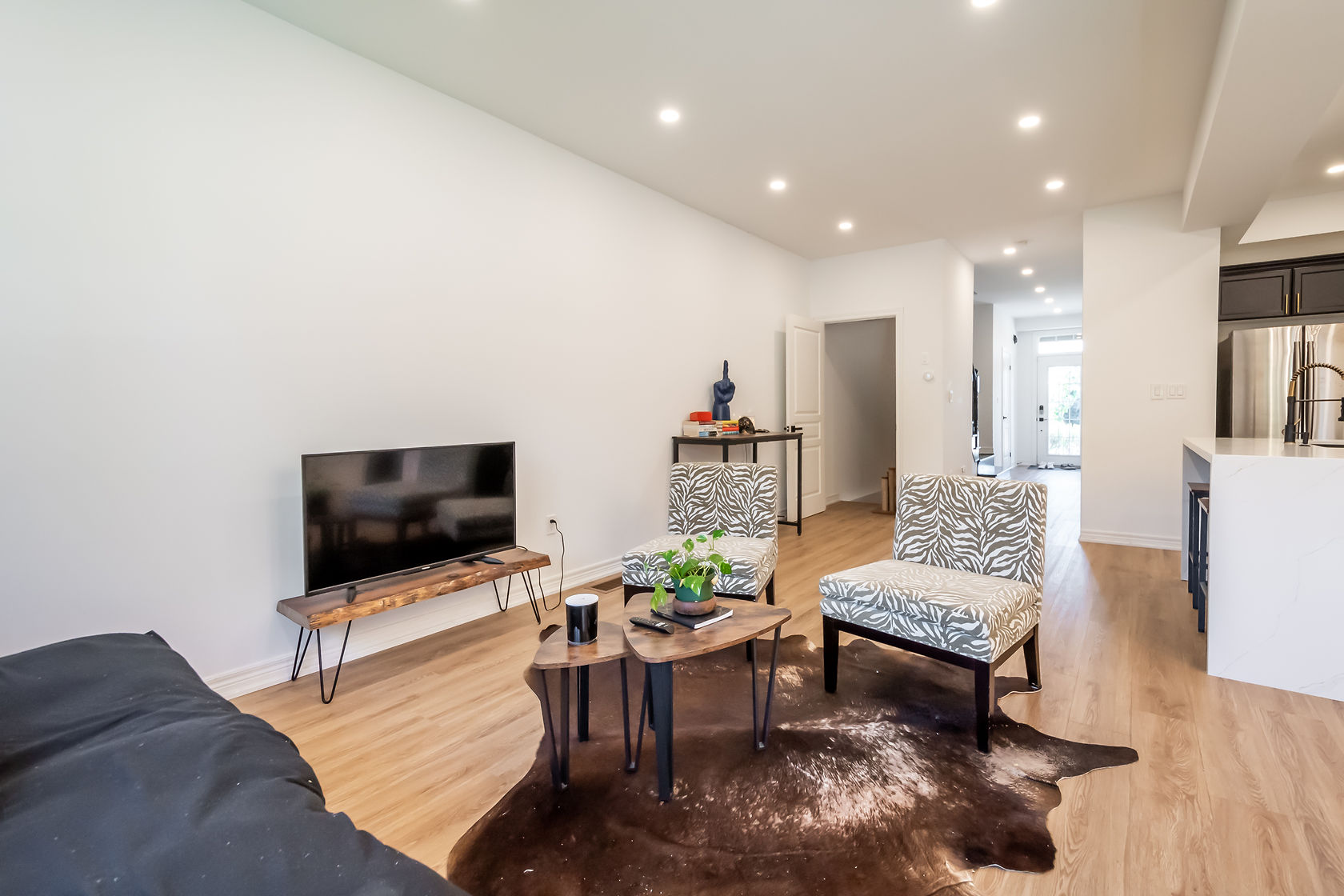 Wide-angle finished living room with warm lighting and clean modern painted finishes — Stonehenge, Hamilton | MTC Renovations