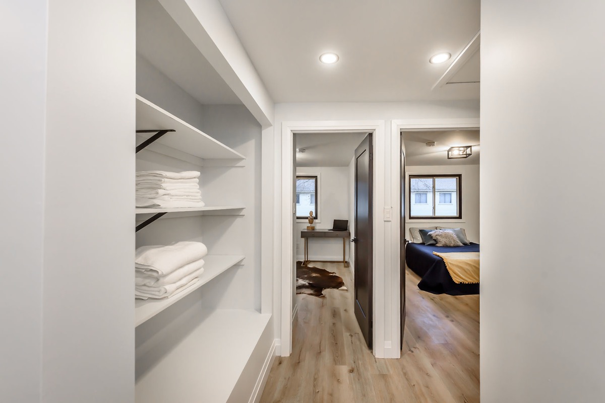 Finished hallway with built-in linen storage, clean sight lines, and crisp painted walls — Gateshead, Hamilton | MTC Renovations